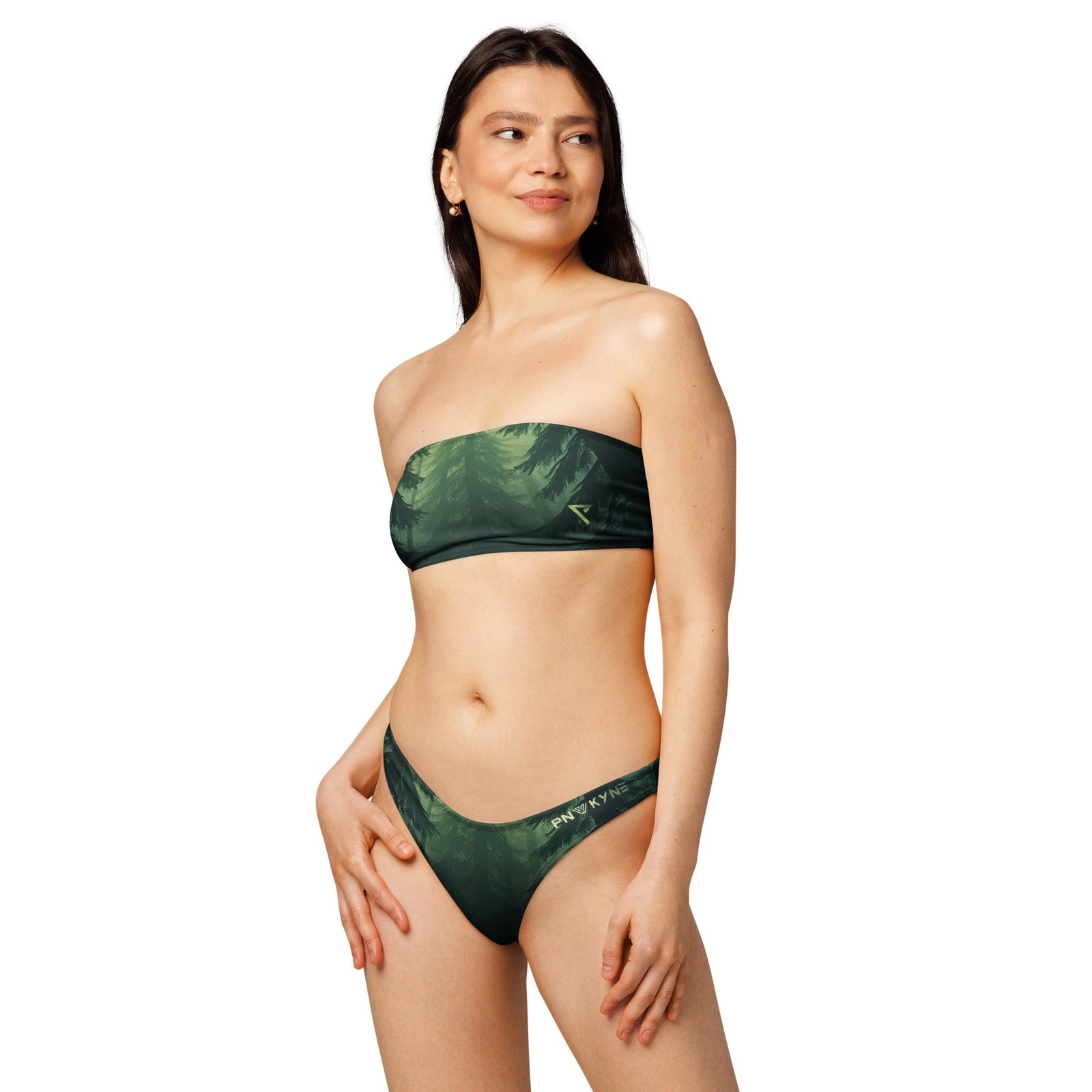 Woman wearing a green bandeau bikini with a Pacific Northwest printed design and the PNW Kyne logo on a white background