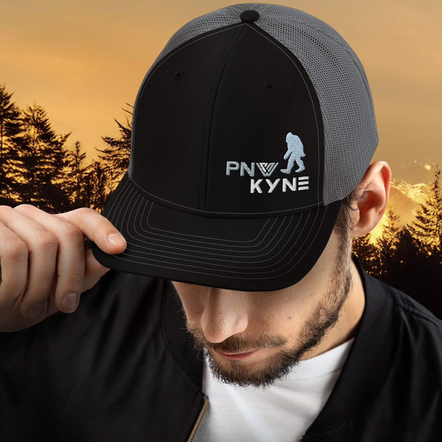 Man showing off a Sasquatch Scout Bigfoot Trucker Hat in the Pacific Northwest