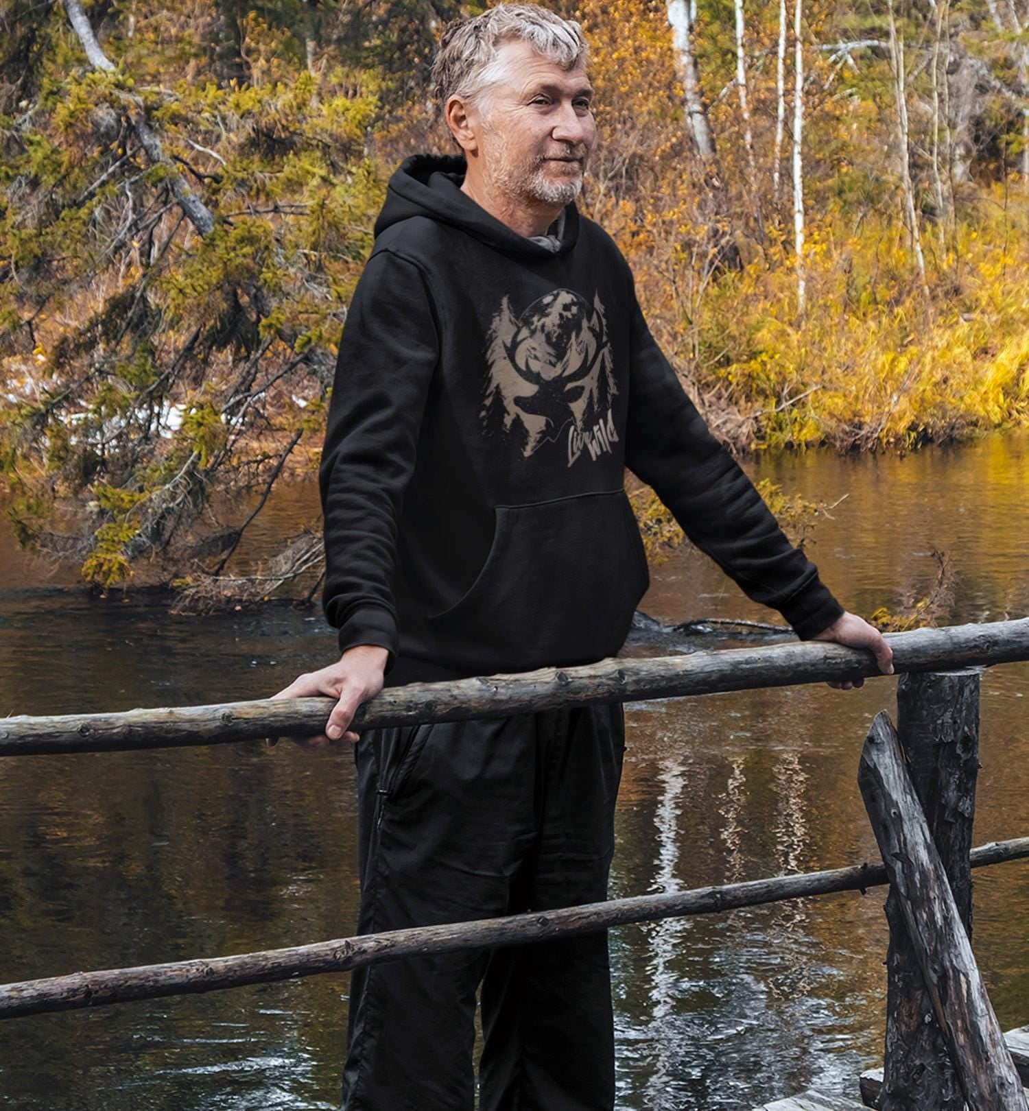 Man on a bridge wearing a PNW Live Wild Deer Pullover Hoodie Sweatshirt