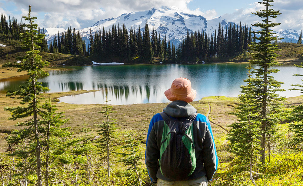 4 Day Hikes in the North Cascades - Hiker overlooking a lake - PNW Life Header Image