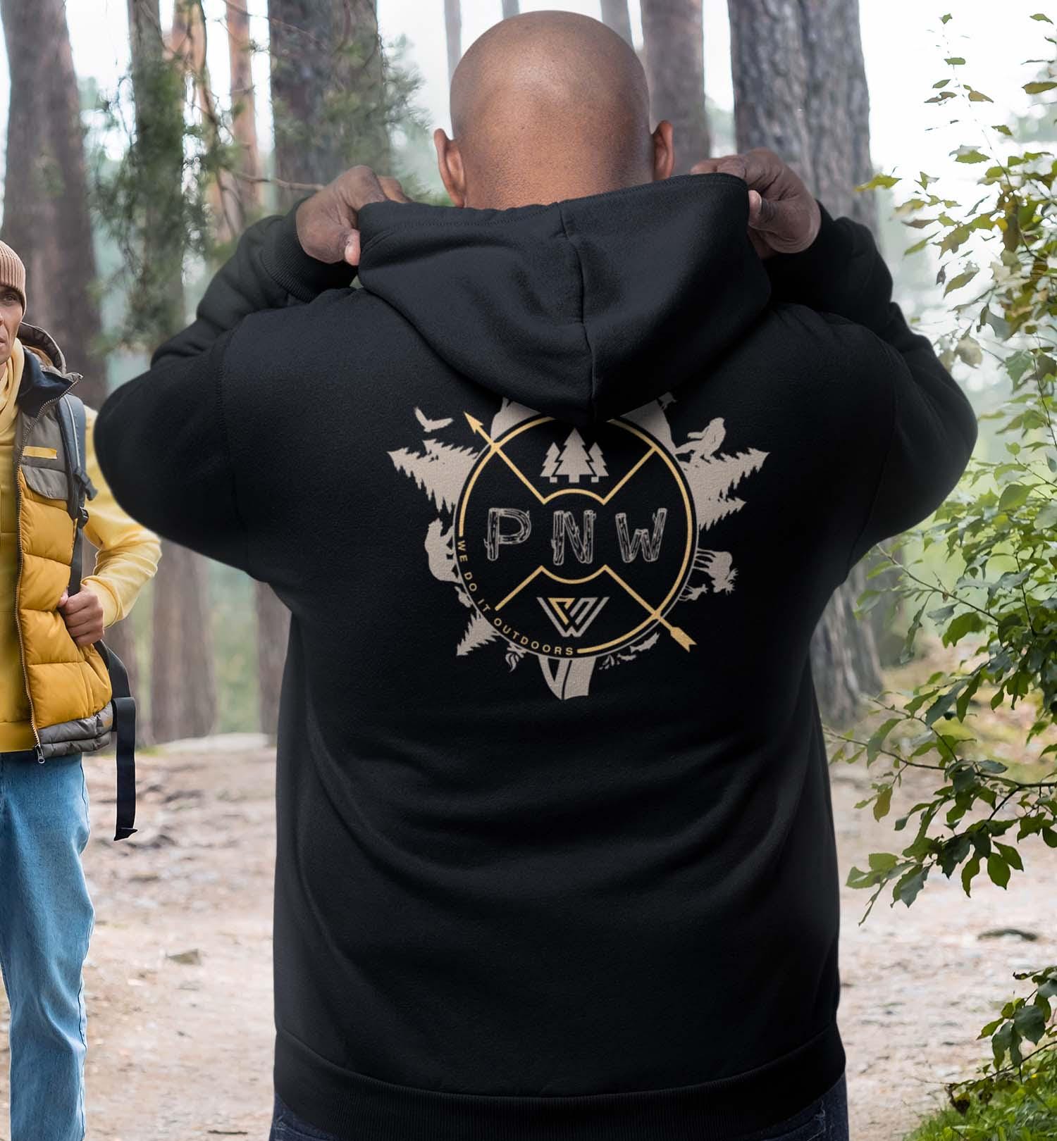 Dark blue hoodie with PNW compass rose surrounded by trees and animals graphic on the back against a white background