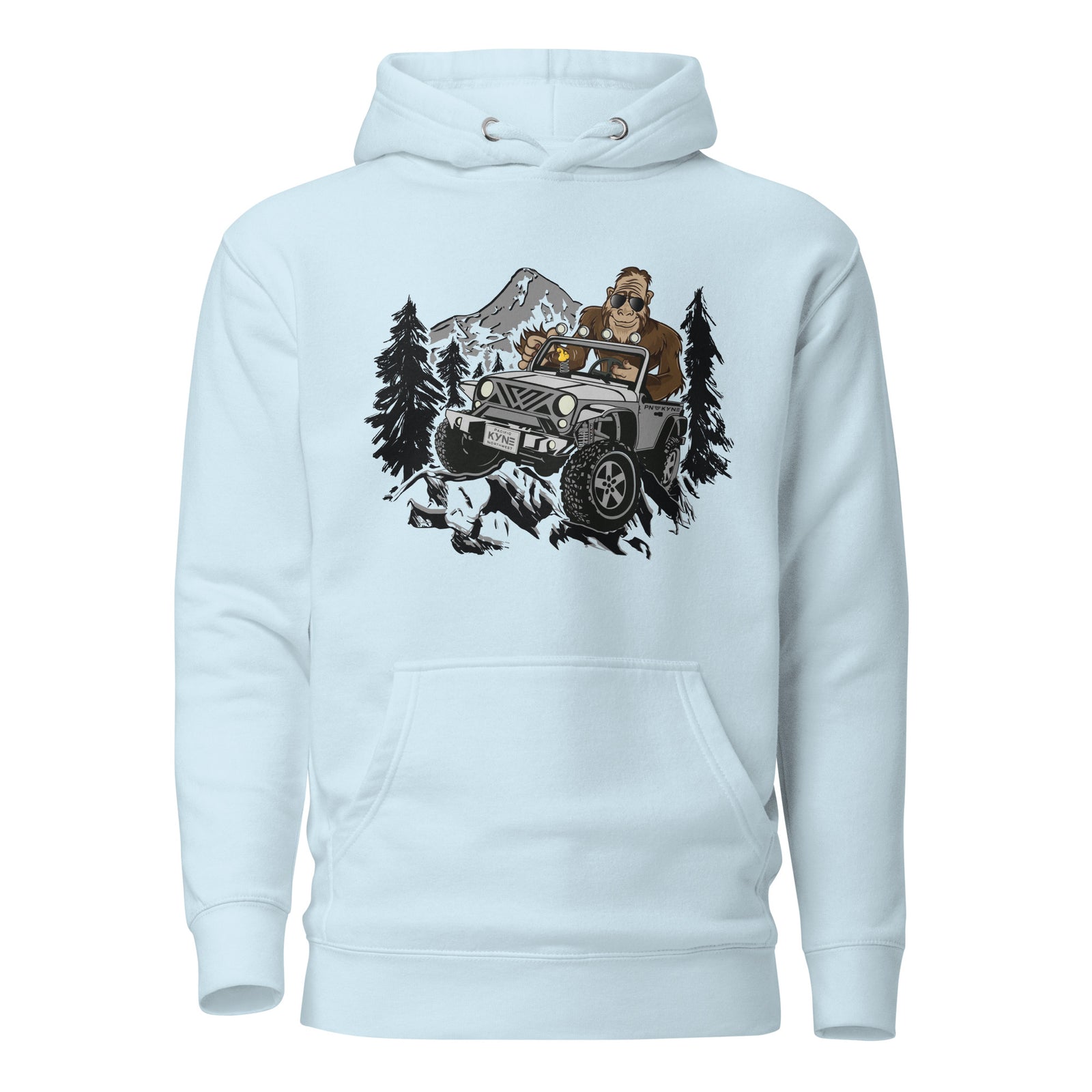 A blue pullover hoodie with an image of Bigfoot driving a jeep-like vehicle with Mt. Hood in the background, surrounded by trees.