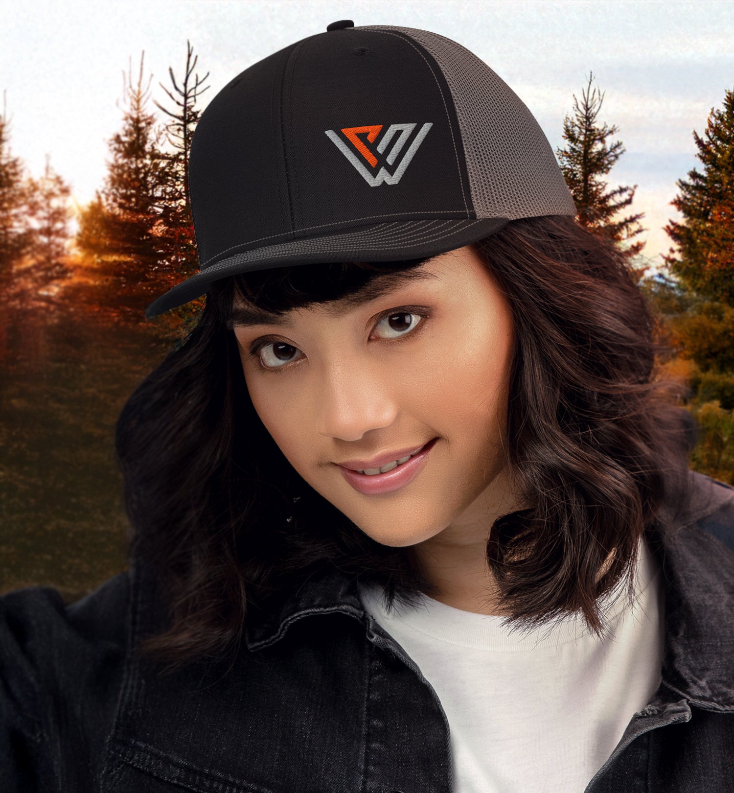 PNW KYNE Classic Logo Trucker Hat on a woman in the Pacific Northwest woods