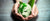 Hands holding a green planet earth