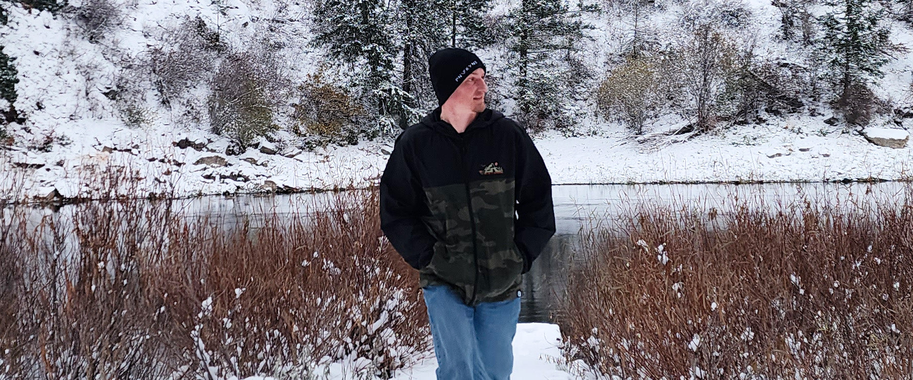 Joe from PNW KYNE at a snowy river bank in winter