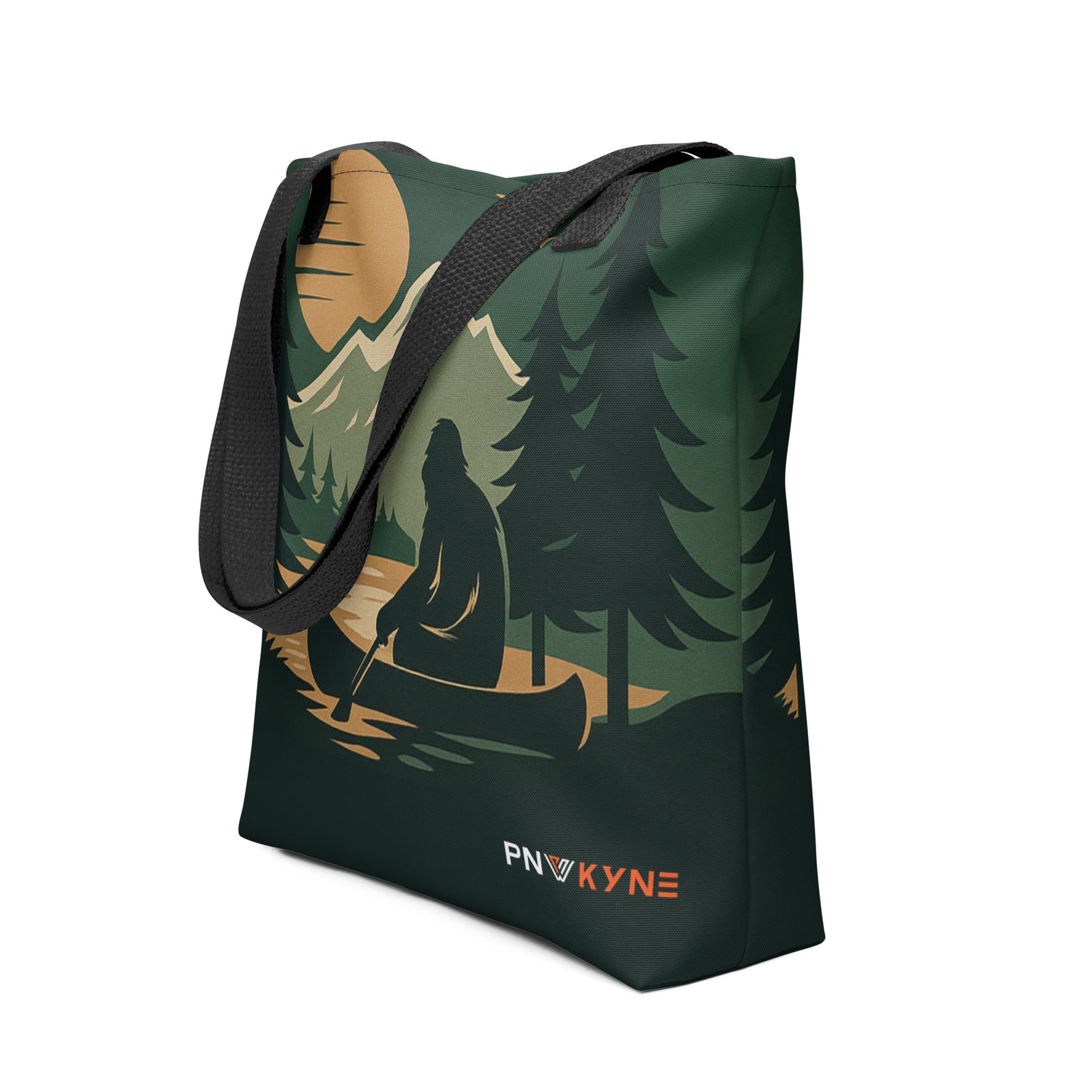 Tote bag with nature-themed design depicting a sasquatch in a boat on the lake and 'PNW Kyne' branding on a white background