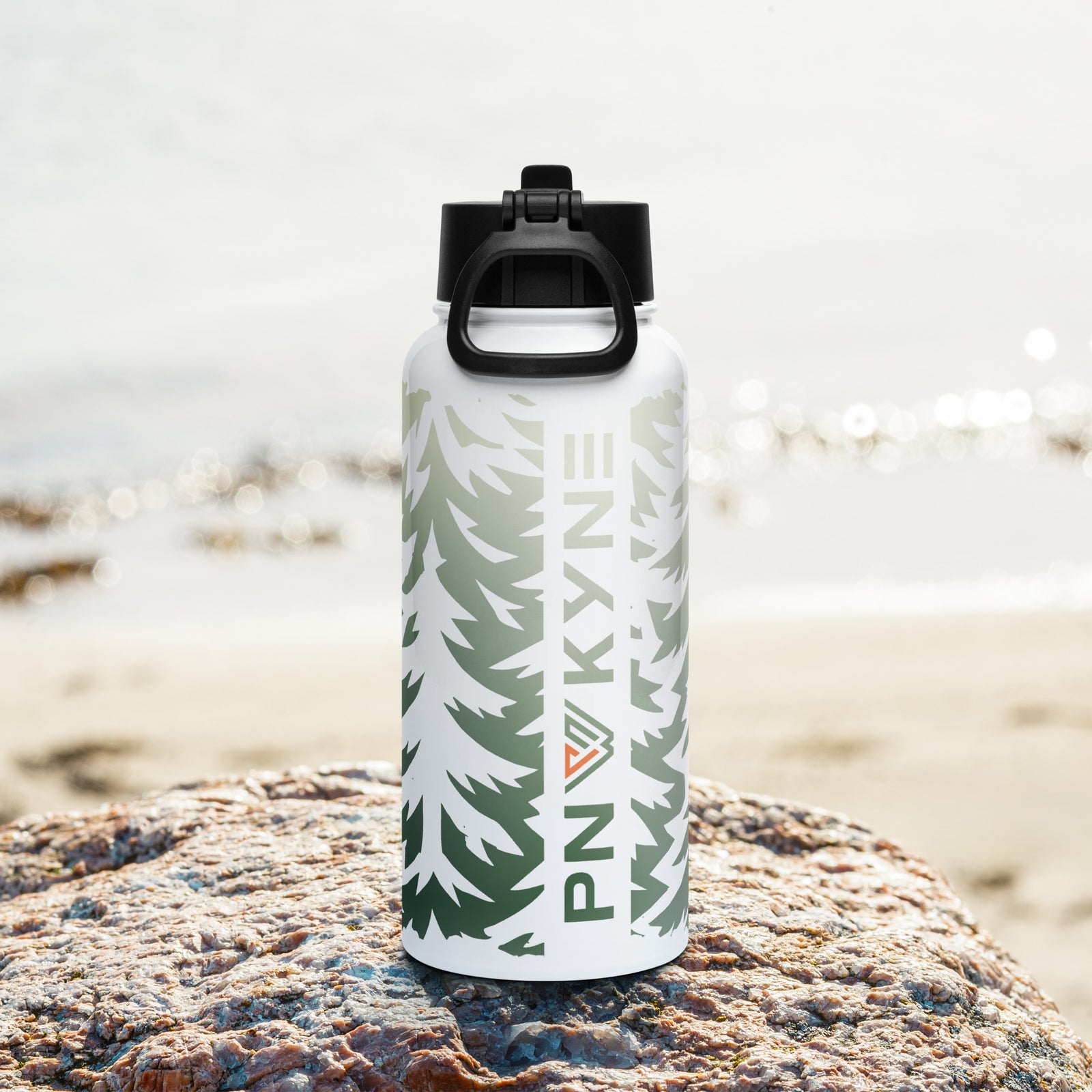 A stainless steel water bottle with a green and white PNW forest design, a black BPA-free straw lid, and a white straw.