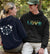 Woman with Around the PNW hoodie and Man with Pacific Northwest LOVE Sweatshirt smiling at each other